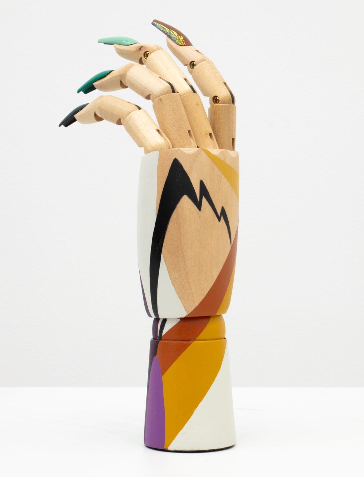 A three-dimensional cosmetic sculpture by artist Circe Irasema incorporating acrylic nails and eyeshadows.