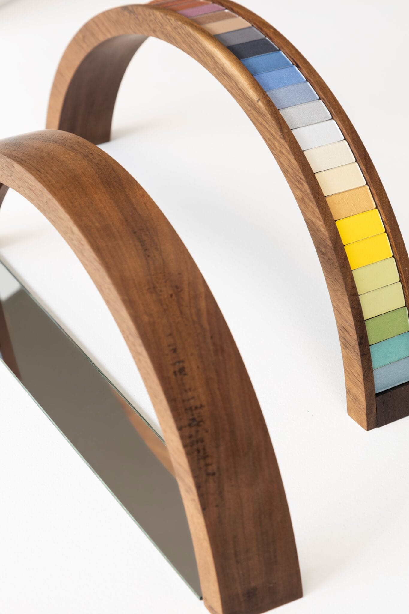 A close-up of a mixed-media makeup painting where cosmetic powders blend with acrylic paint.