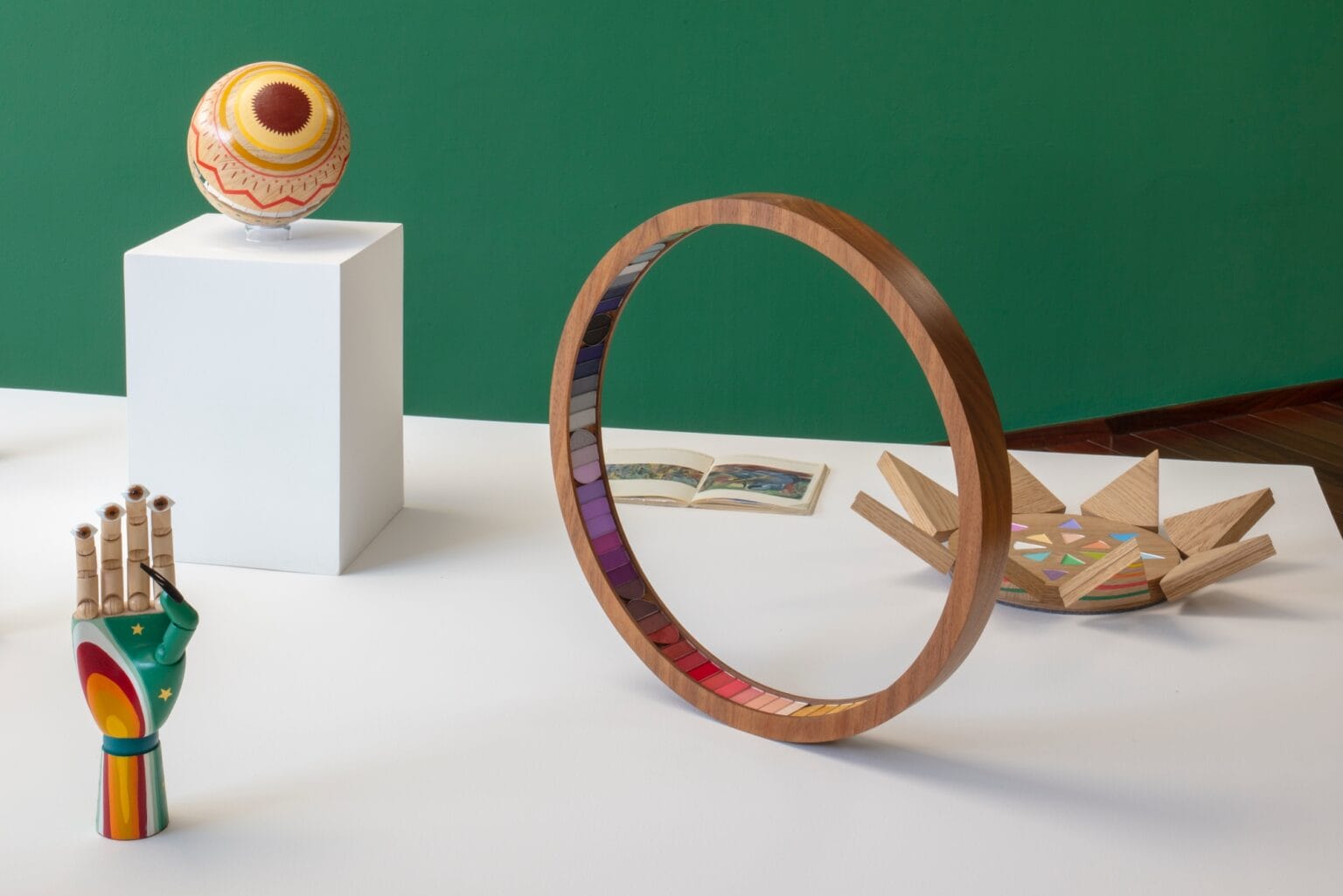 A detailed view of an alternative makeup art technique using cosmetic powders on a wooden board.