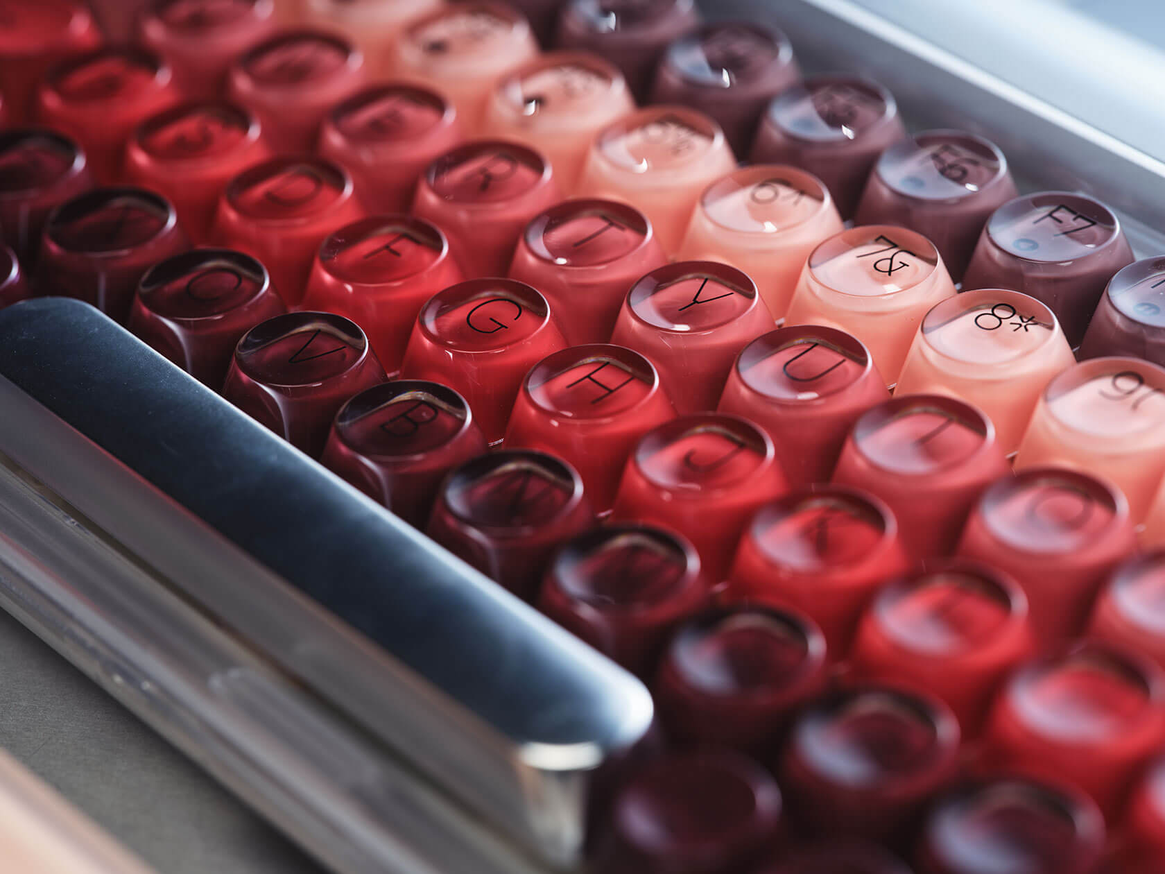 Close-up of cute mechanical keyboard keycaps showing gradient pink and rose details