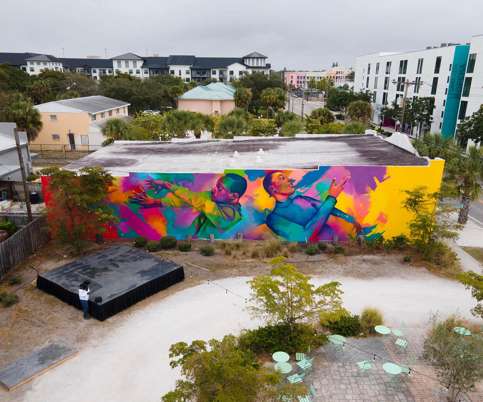 Large-scale street art mural with vibrant colors and bold abstract composition